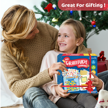 Load image into Gallery viewer, Woman and child holding a 'My Gratitude Journal' book with a Christmas tree in the background.